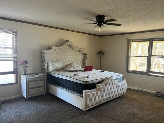 bedroom featuring a textured ceiling, visible vents, dark colored carpet, and ornamental molding