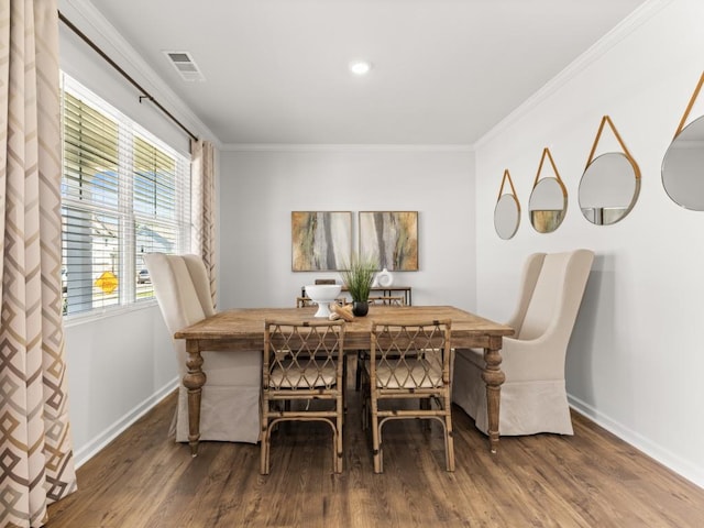 dining area featuring hardwood / wood-style floors and ornamental molding