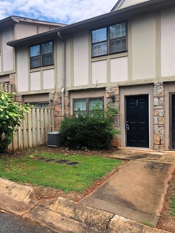 1151 Rankin St Unit 21A, Stone Mountain, GA 30083 - view of front of property with stone siding, stucco siding, and central AC unit