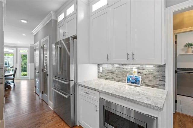 2510 Wood Creek Ct, Dacula, GA 30019 - kitchen featuring appliances with stainless steel finishes, crown molding, white cabinets, dark wood-style flooring, and glass insert cabinets