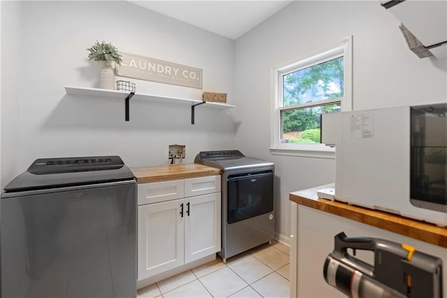 2510 Wood Creek Ct, Dacula, GA 30019 - laundry room featuring cabinet space, independent washer and dryer, and light tile patterned floors