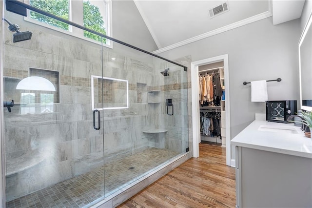 2510 Wood Creek Ct, Dacula, GA 30019 - bathroom with crown molding, lofted ceiling, vanity, a shower stall, and wood finished floors