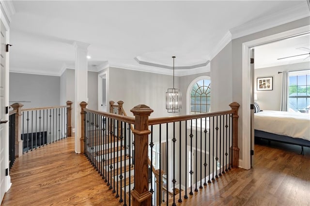 2510 Wood Creek Ct, Dacula, GA 30019 - hallway with wood finished floors, an upstairs landing, ornamental molding, and a chandelier