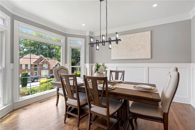 2510 Wood Creek Ct, Dacula, GA 30019 - dining space featuring ornamental molding, wood finished floors, wainscoting, a decorative wall, and a chandelier
