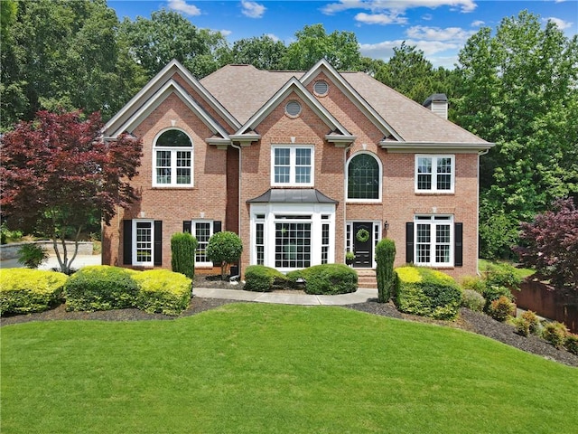 2510 Wood Creek Ct, Dacula, GA 30019 - view of front of property with a front lawn, brick siding, and a chimney
