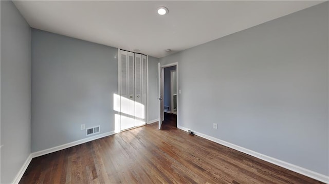 empty room with dark hardwood / wood-style floors