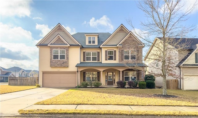 view of front of property with a garage and a front lawn