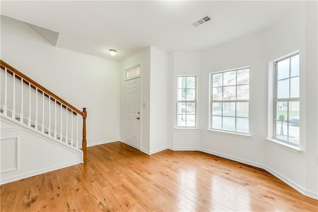 2520 Laurel Cir NW, Atlanta, GA 30311 - foyer entrance with healthy amount of natural light, stairs, light wood finished floors, and baseboards
