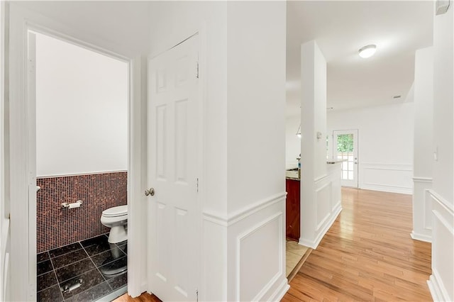 2520 Laurel Cir NW, Atlanta, GA 30311 - bathroom with wainscoting, toilet, tile walls, and wood finished floors