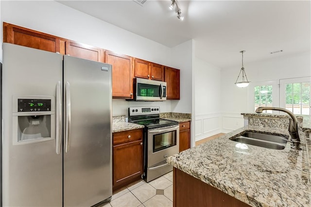 2520 Laurel Cir NW, Atlanta, GA 30311 - kitchen with appliances with stainless steel finishes, a sink, light stone countertops, decorative light fixtures, and light tile patterned floors