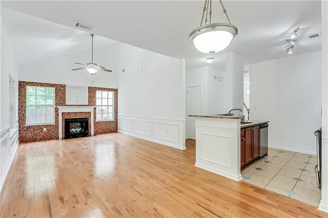 2520 Laurel Cir NW, Atlanta, GA 30311 - unfurnished living room with a ceiling fan, light wood-style flooring, a decorative wall, wainscoting, and a fireplace