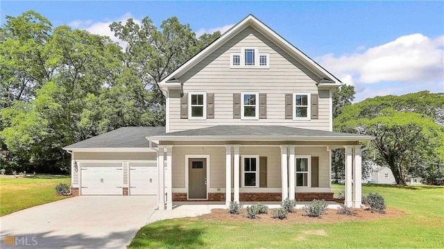 view of front of home with covered porch, a front yard, and a garage