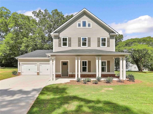 view of front of home with a front yard, a garage, and covered porch