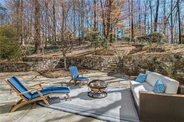 view of patio / terrace featuring an outdoor living space with a fire pit