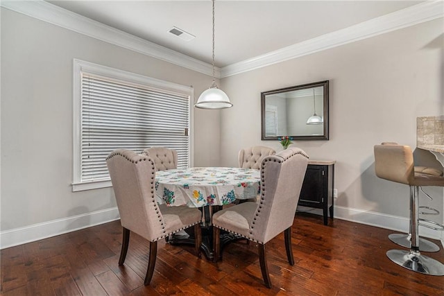 dining room with crown molding and dark hardwood / wood-style floors