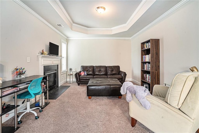 carpeted living room featuring ornamental molding and a raised ceiling