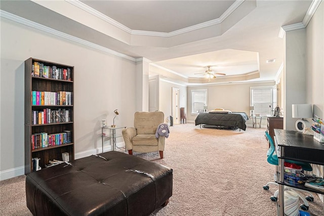 bedroom with ceiling fan, carpet, ornamental molding, and a raised ceiling