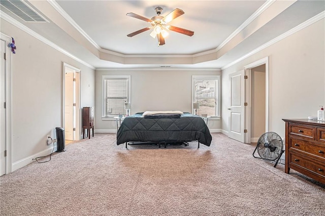 carpeted bedroom with ceiling fan, crown molding, and a tray ceiling