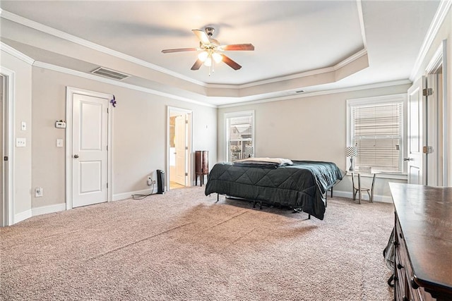 bedroom featuring ceiling fan, carpet, a tray ceiling, and ornamental molding