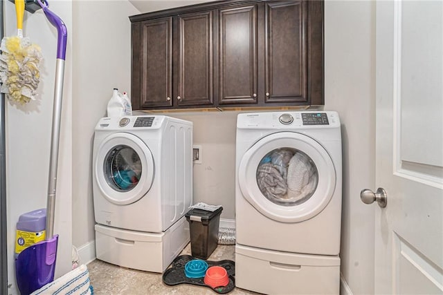 laundry room featuring cabinets and washing machine and clothes dryer