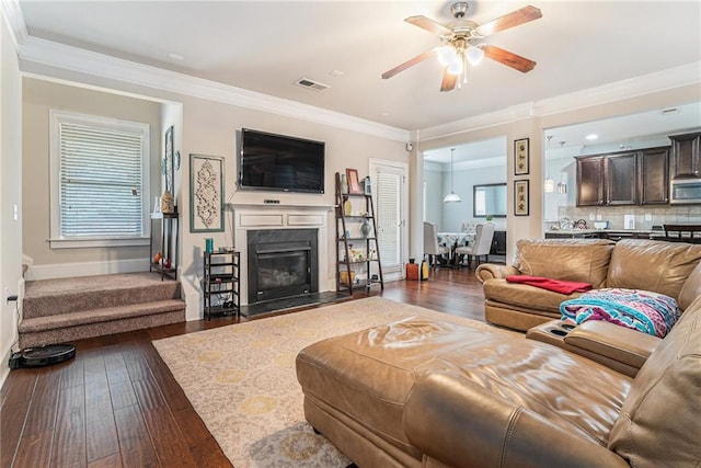 living room with ceiling fan, dark hardwood / wood-style flooring, and ornamental molding