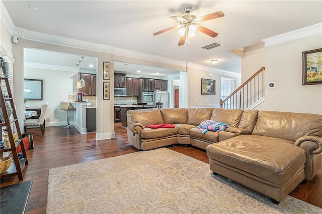 living room featuring ceiling fan, dark wood-type flooring, and ornamental molding