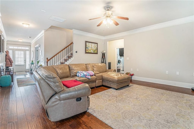 living room with ceiling fan, dark hardwood / wood-style floors, crown molding, and washer / dryer