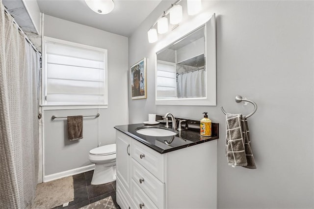 bathroom featuring vanity, curtained shower, and toilet