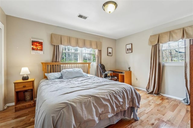 bedroom with visible vents, baseboards, and light wood-style flooring