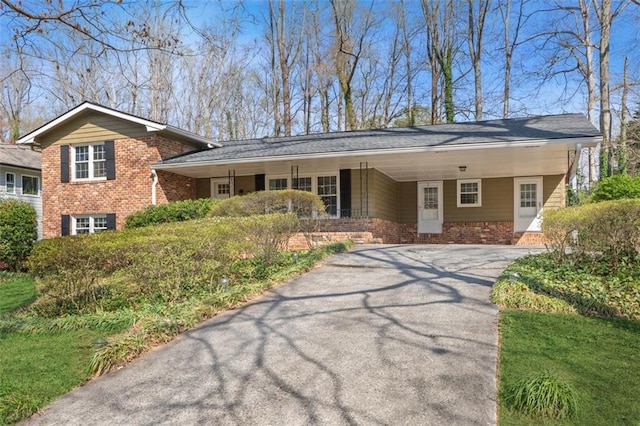 view of front of property featuring an attached carport and driveway