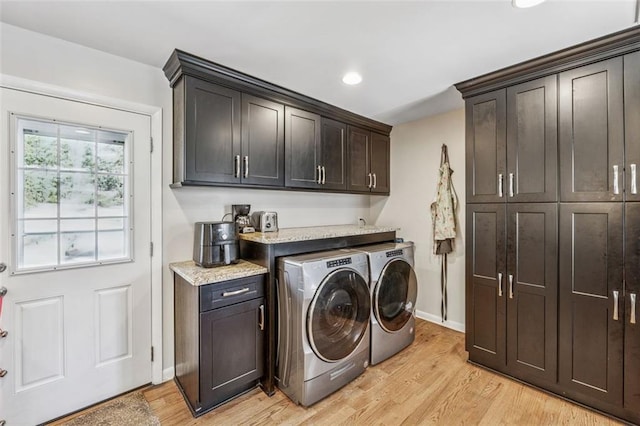 laundry room with baseboards, recessed lighting, light wood-style floors, cabinet space, and separate washer and dryer