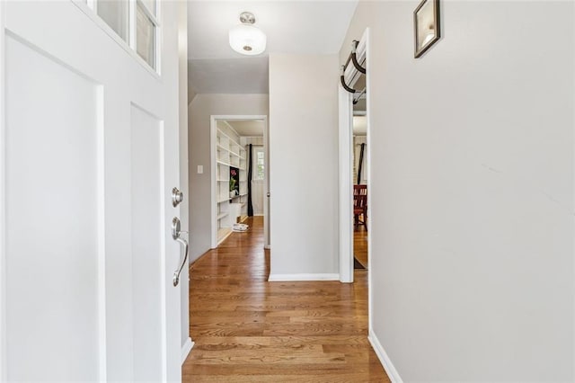interior space featuring light wood-style flooring and baseboards