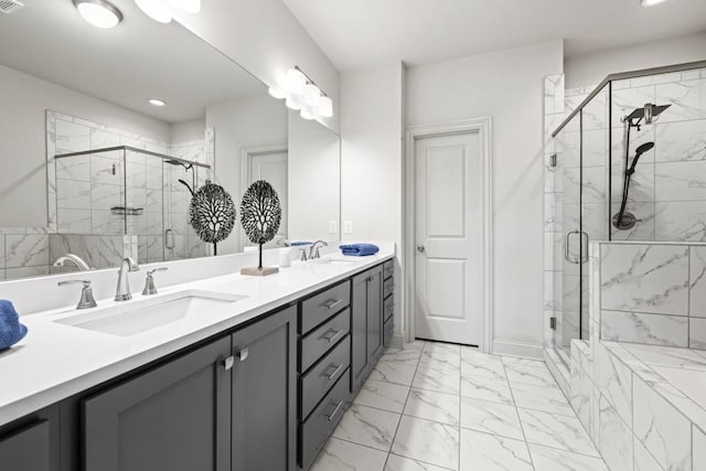 full bath with marble finish floor, a sink, a shower stall, and double vanity