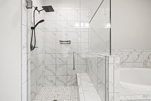 bathroom featuring a stall shower and a bath