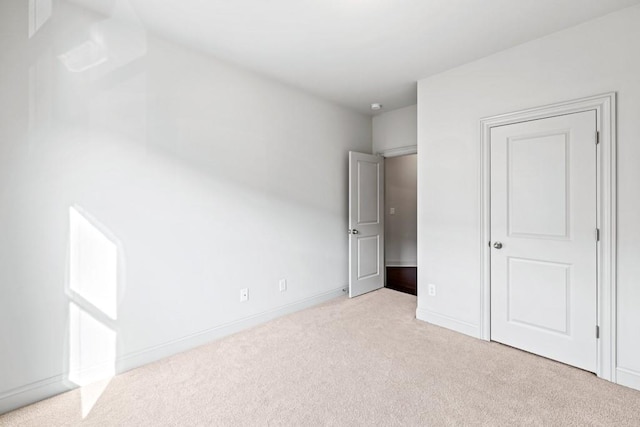 unfurnished bedroom with carpet floors and baseboards