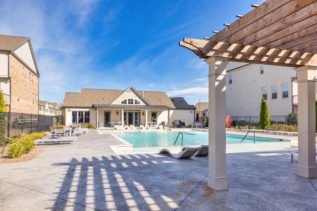 community pool with a patio area, fence, and a pergola