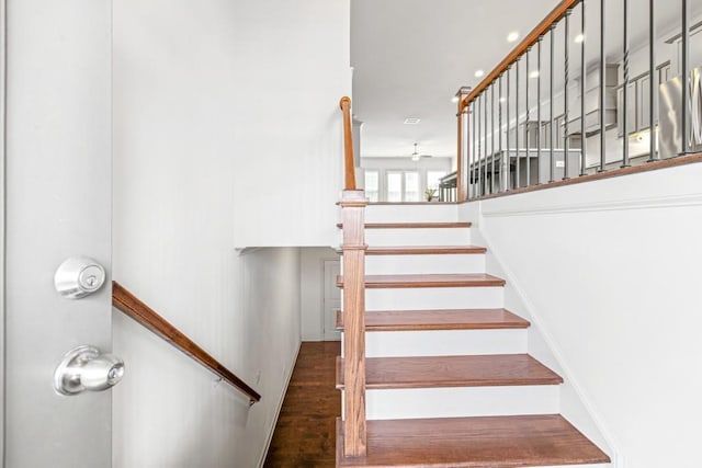 stairs featuring wood finished floors