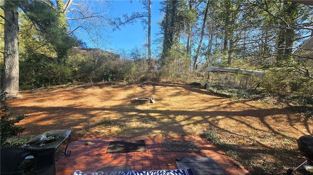 view of yard featuring a patio and a fire pit