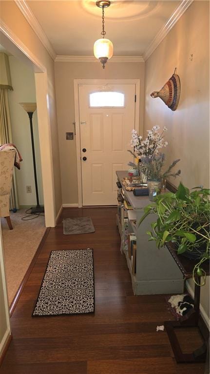 doorway to outside with crown molding and dark wood-type flooring