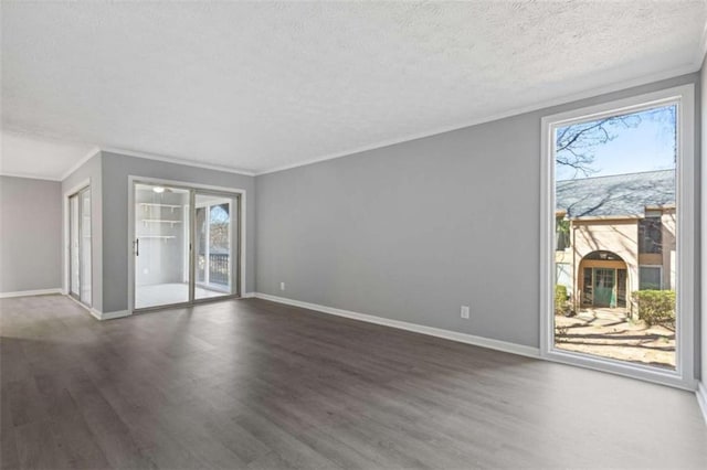 unfurnished living room with a healthy amount of sunlight, a textured ceiling, baseboards, and wood finished floors