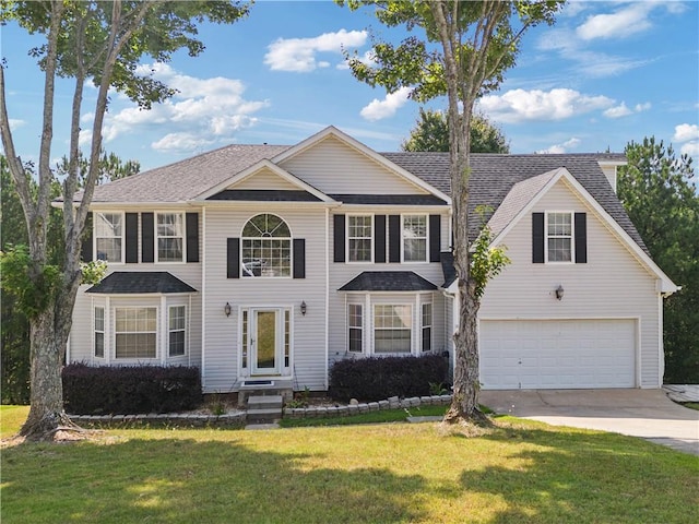 view of front of property featuring a garage and a front yard