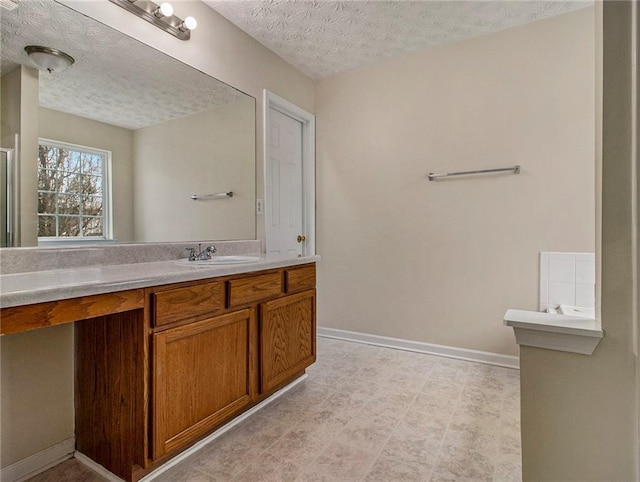 bathroom with vanity and a textured ceiling