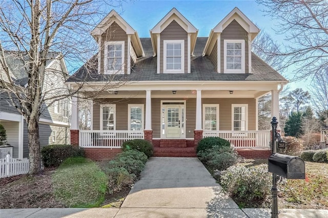 view of front facade with fence and a porch