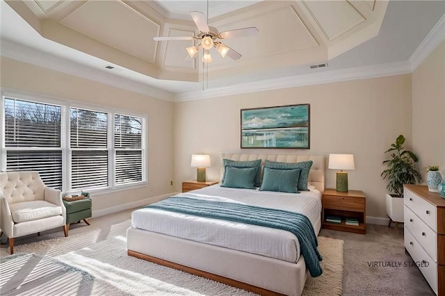 carpeted bedroom featuring baseboards, visible vents, and a raised ceiling