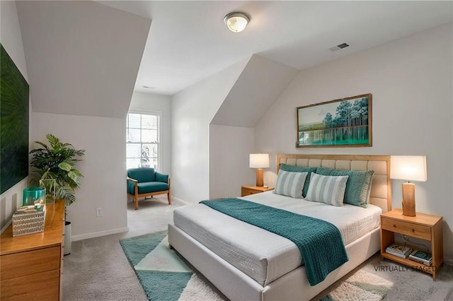 carpeted bedroom with baseboards, lofted ceiling, and visible vents