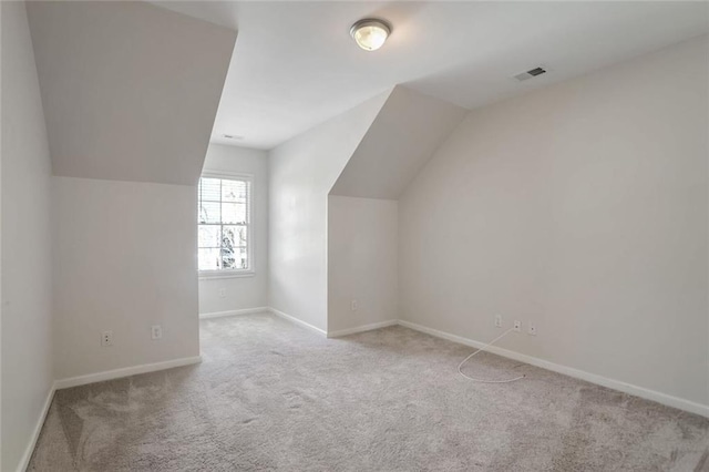bonus room with baseboards, visible vents, carpet flooring, and vaulted ceiling