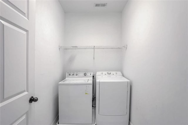 laundry area featuring visible vents, laundry area, and washer and dryer