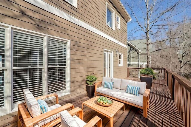wooden terrace with outdoor lounge area