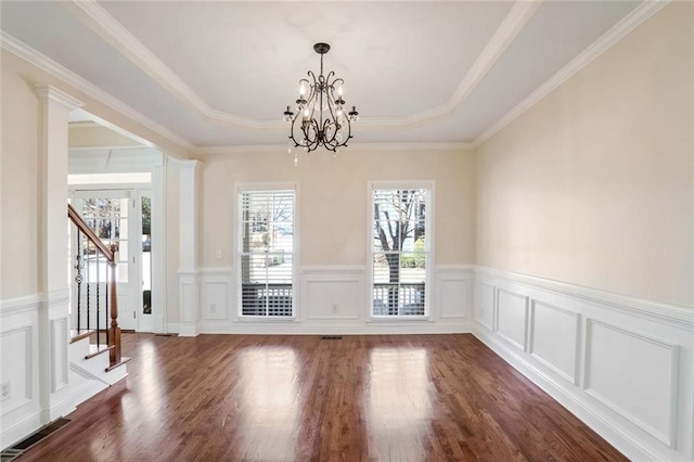 unfurnished dining area featuring stairway, an inviting chandelier, dark wood finished floors, a raised ceiling, and visible vents