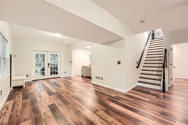 162 Taylor Ridge Way, Milton, GA 30004 - unfurnished living room featuring french doors, wood finished floors, and stairs
